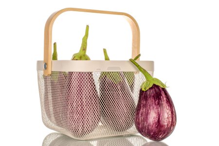 Photo for Several organic ripe eggplants in a basket, macro, isolated on white background. - Royalty Free Image