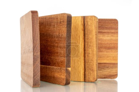 Photo for Set of four wooden coasters made of pine, macro, isolated on white background. - Royalty Free Image