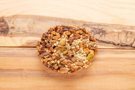 Photo for One Thaler cookie with nuts, honey on wooden table, macro, top view. - Royalty Free Image
