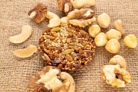 Photo for One Thaler cookie with nuts on a jute cloth, macro, top view. - Royalty Free Image