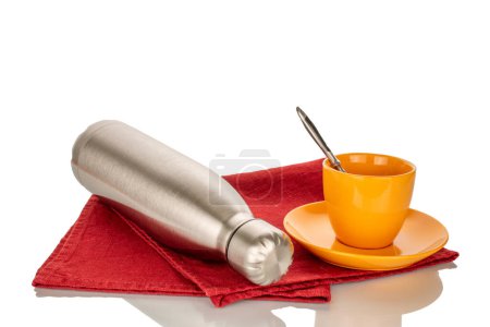 Photo for One vacuum insulated metal bottle for water or coffee and a cup of coffee on a red napkin on a white background. - Royalty Free Image