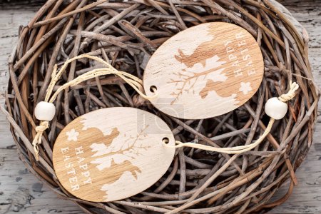 Wooden decoration for Easter in a bird's nest, macro, top view.