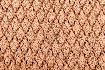 Foto de Textura de tejido de lana de punto para papel pintado tonificado con pelusa de melocotón color del año 2024 - Imagen libre de derechos