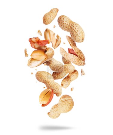 Whole and crushed peanuts close-up in the air on a white background