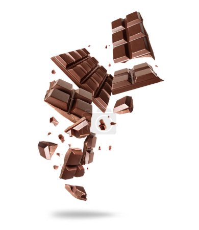 Bar of dark chocolate crushed in the air on a white background