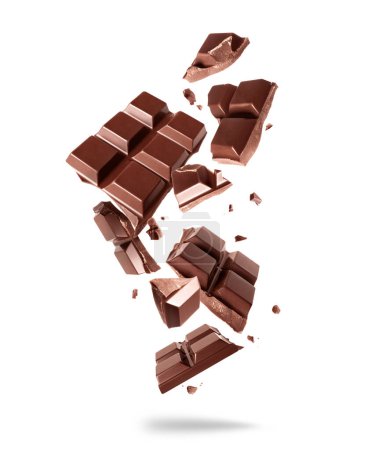 Broken bar of dark chocolate in the air on a white background