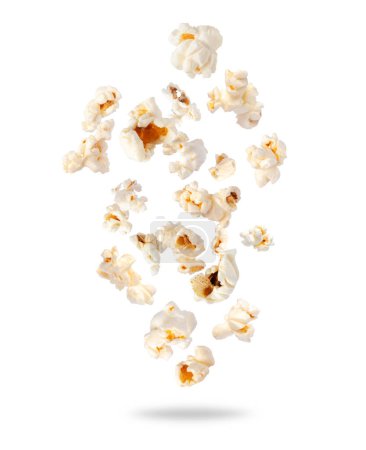 Téléchargez les photos : Popcorn pelucheux dispersé dans l'air gros plan sur un fond blanc. Chute aléatoire de maïs soufflé - en image libre de droit