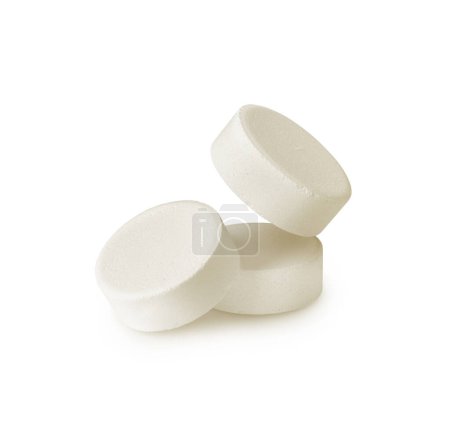 Three soluble tablets isolated on a white background. Effervescent multivitamin pills close-up