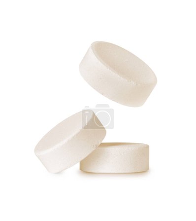 Three soluble tablets close-up. Effervescent multivitamin pills isolated on a white background