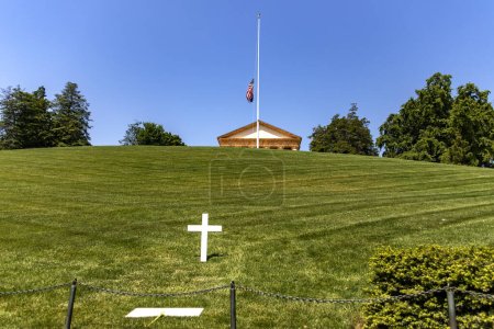 The monumental pantheon at Arlington National Military Cemetery, with a white marble cross and tomb in Washington DC, the capital of the USA.