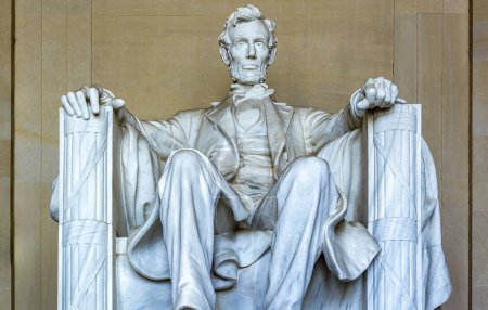 Georgia white marble statue of the 16th US President Abraham Lincoln seated in his armchair and footrest at the National Mall Temple, better known as the Lincoln Memorial in Washington DC.