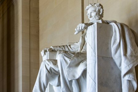 The Memorial of Abraham Lincoln seated in his armchair and footrest, built of white Georgia marble and located in the temple of the National Mall of the American capital Washington DC (USA).