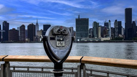 Binoculars on the pier viewer and observer Long Island is an island that extends across New York (USA).