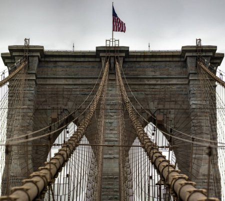 Photo for The Brooklyn Bridge linking the boroughs of Manhattan and Brooklyn in New York City (USA) was the largest suspension bridge in the world, a record span until 1889. - Royalty Free Image