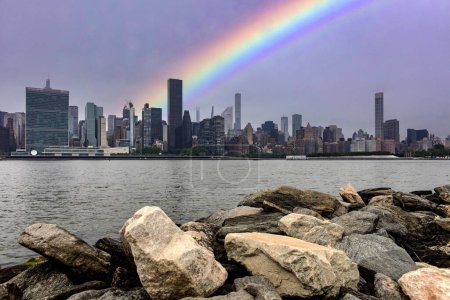 Photo for The skyline of the Big Apple with a rainbow seen from the cliff of Long Island which is an island that extends across New York (USA) and one of the best viewpoints in Manhattan. - Royalty Free Image