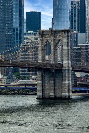 Photo for Vertical photo of the Brooklyn Bridge linking the boroughs of Manhattan and Brooklyn in New York City (USA), this bridge is one of the most famous and well known in the Big Apple. - Royalty Free Image