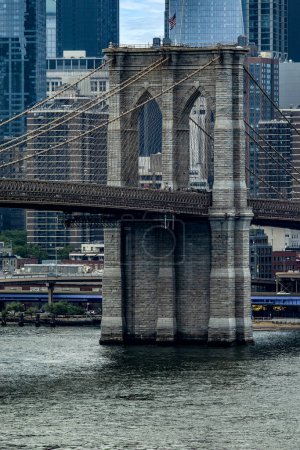 Photo for Vertical photo of the famous Brooklyn Bridge linking the boroughs of Manhattan and Brooklyn in New York City (USA), this bridge is one of the most famous and well known in the Big Apple. - Royalty Free Image