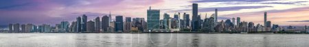 Great panoramic view of the Big Apple skyline seen at sunrise from Long Island which is an island that extends across New York (USA) and one of the best viewpoints in Manhattan.