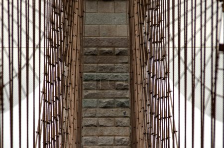 Photo for Photo of the central cables of the Brooklyn Suspension Bridge linking the boroughs of Manhattan and Brooklyn in New York City (USA), the largest suspension bridge in the world until 1889. - Royalty Free Image