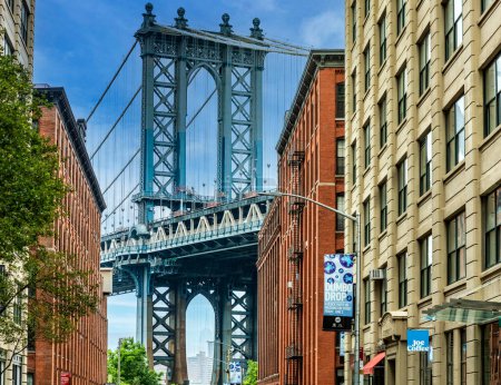Photo for Wonderful sunny day in Dumbo, the trendy Brooklyn neighborhood with picturesque views of the Manhattan skyline and its bridge, famous in New York City (USA). - Royalty Free Image