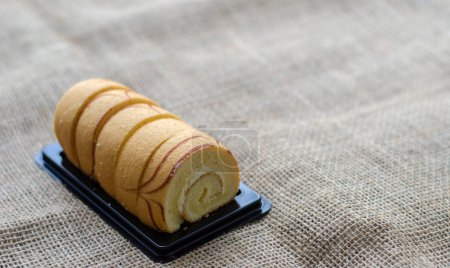 Photo for Mini vanilla roll cake, swiss roll cake or sponge roll with Vanilla flavor for a coffee break. Thai call Jam Rolls. with copy space - Royalty Free Image
