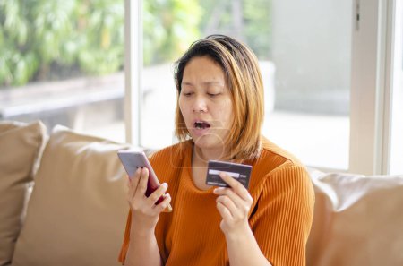 Photo for Shocked face of woman, scammer steals money from online transaction - Royalty Free Image