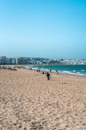 Photo for People walking on a Mediterranean beach in Tanger, Morocco - Royalty Free Image
