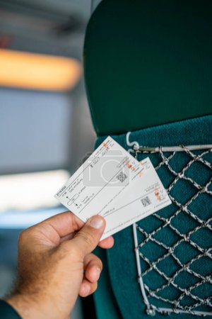 Photo for A man holding two railway tickets inside a high speed train in Morocco - Royalty Free Image