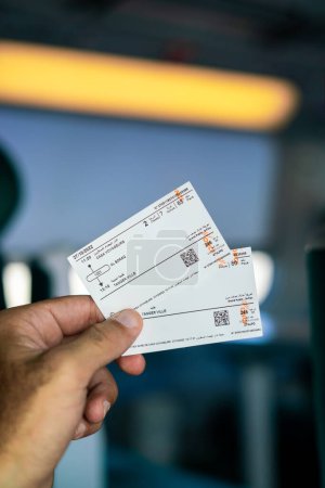 Photo for A man holding two railway tickets inside a high speed train in Morocco - Royalty Free Image