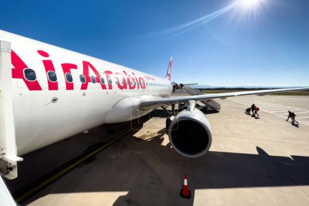 Téléchargez les photos : Passengers boarding an Air Arabia commercial airplane at Fes Sais international airport in Morocco - en image libre de droit