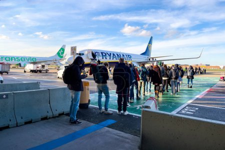 Photo for Passengers boarding a Ryanair commercial airplane at Zaventem international airport in Belgium - Royalty Free Image