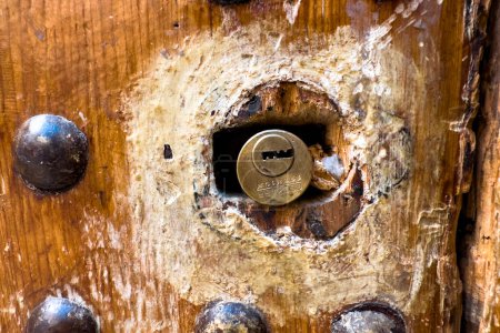 Photo for Close-up of a traditional keyhole on a wooden door - Royalty Free Image