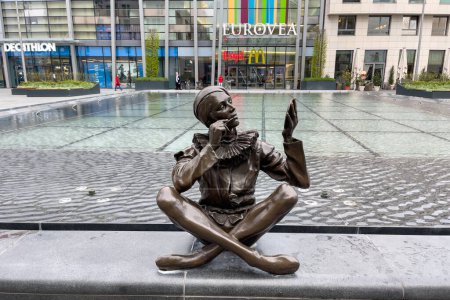 Photo for Bronze statue of a person sitting on the edge of the fountain in front of Eurovea shopping center in Bratislava, Slovakia - Royalty Free Image