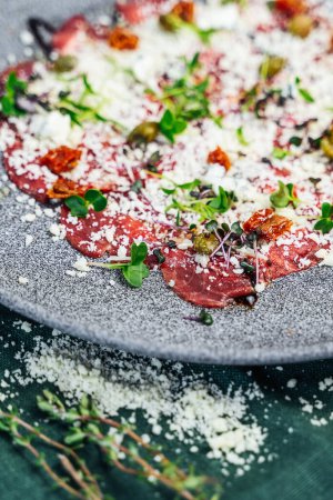 A mouth-watering close-up of veal carpaccio, served in a fancy restaurant