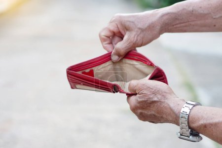 Photo for Closeup senior' man hands open empty wallet. Concept, no money, economic crisis. Financial problems. - Royalty Free Image