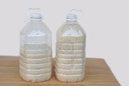 Photo for Two plastic bottles that contain grains of rice to prevent from dust or insects. DIY. Concept, reuse plastic bottle. Zero waste. - Royalty Free Image