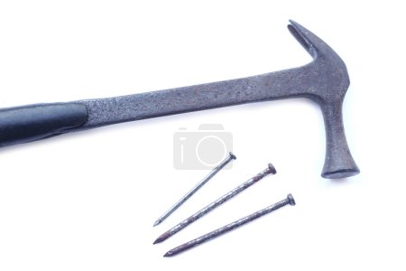 Photo for Old hammer and three rusty iron spike nails isolated on white background. Concept, carpentry and construction tools. - Royalty Free Image