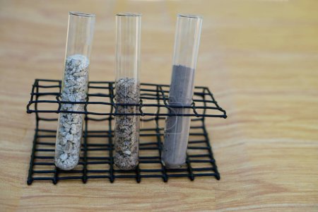 Foto de Test glass tubes that contain sample of different soil. Concept, soil quality inspection, research and science experiment. Laboratory. Find the best from different soil type and source - Imagen libre de derechos