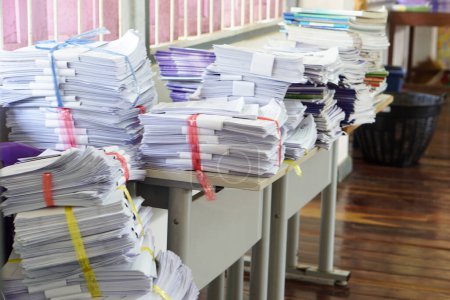 Photo for Stack of used paper test after the examination in classroom, combine to use next time or take to recycle process. Concept, paper garbage management. Reduce reuse, recycle for environment. Sort garbage - Royalty Free Image