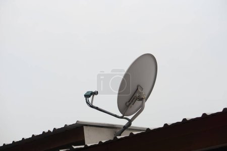 Satellite receiver antenna installed on roof. Concept, technology for communication, global broadcast for digital reception through TV.  