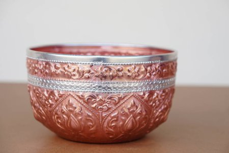 Photo for Thai traditional copper silver bowl. Buddhists use this bowl to temple or do ceremony, ritual that involves  Buddhism and use in Thai Songkran festival  as water bowl. Handicrafts style of Thailand - Royalty Free Image