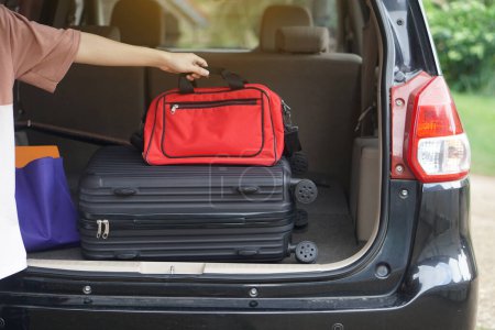 Photo for Close up man put bags and luggage to put in car. Concept, prepare for travelling. Vacation, holiday or weekend trip. Prepare and ready go. - Royalty Free Image