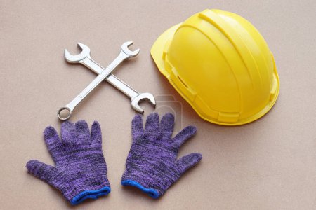 Photo for Handyman kits with yellow protective hard hat, gloves and wrenches. Concept, handyman or mechanic tools. Equipment for fixing or repairing, renovation in daily life. - Royalty Free Image
