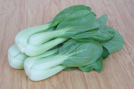 Fresh Bok Choy or Pak Choi or Chinese cabbage on wooden background for cooking. Concept, Organic vegetables. Healthy food. High fibers and vitamins. Food ingredients. 