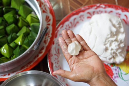 Hand hold flour bun ball for cooking traditional dessert. Concept, Thai food. How to cook, step of cooking. Thai traditional lifestyle, Prepare food for cultural celebration.       