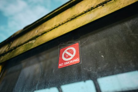 Photo for Mo smoking sign on an Old forgotten rusty Blackpool tram. Famous iconic seaside tourist attraction transport carriages. Rusting historic iconic trams rusting and rotting in a scrapyard. - Royalty Free Image