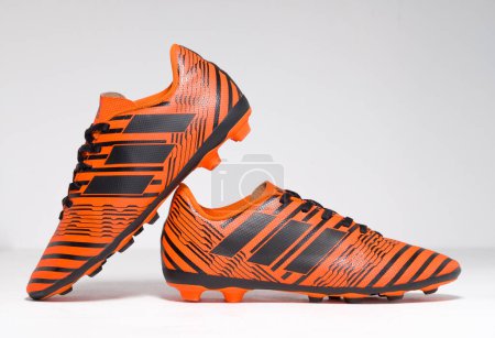 Photo for Kent, uk 01.01.2023 adidas soccer football boots NEMEZIZ 17.4 FXG Junior Trainers Orange training sports boots. iconic soccer shoes. - Royalty Free Image