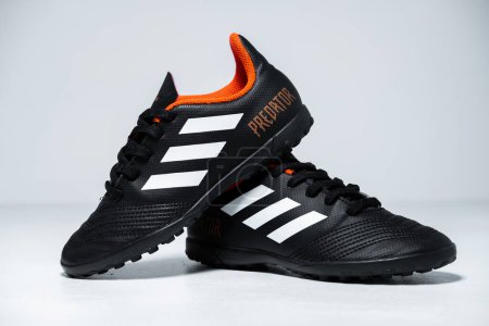 Photo for Kent, uk 01.01.2023 Adidas Predator Tango 18.4 kid Junior Size Kids Football Boots astroturf Junior Trainers black orange and white training sports boots. iconic soccer shoes. - Royalty Free Image
