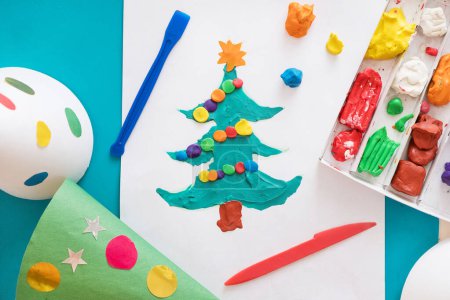 Photo for Making handmade Christmas cards. Childrens DIY concept. Little girl doing Christmas tree decoration or greeting cards from plasticine. Crafts for children - Royalty Free Image