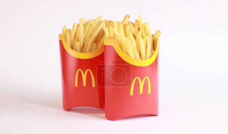 Photo for Kyiv, Ukraine - March 22, 2023: Two large portions of french fries on a light background, empty space for text. McDonald's Corporation is the world's largest fast food restaurant. French fries on a light background - Royalty Free Image